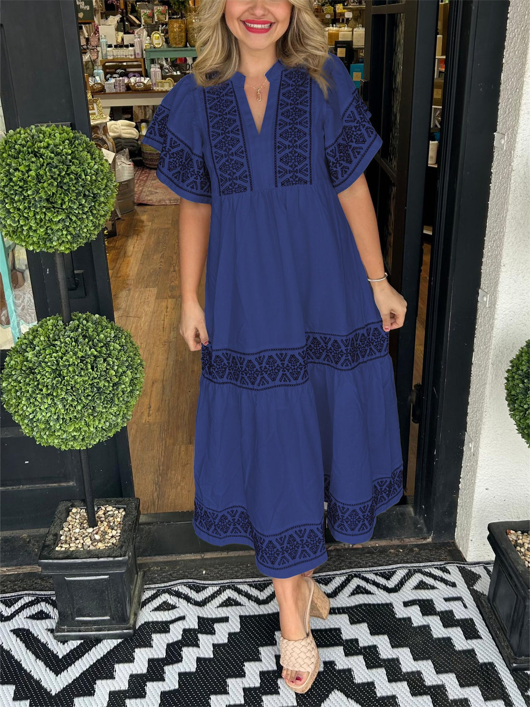 Woman showcasing a loose boho-inspired outfit in a studio setting.