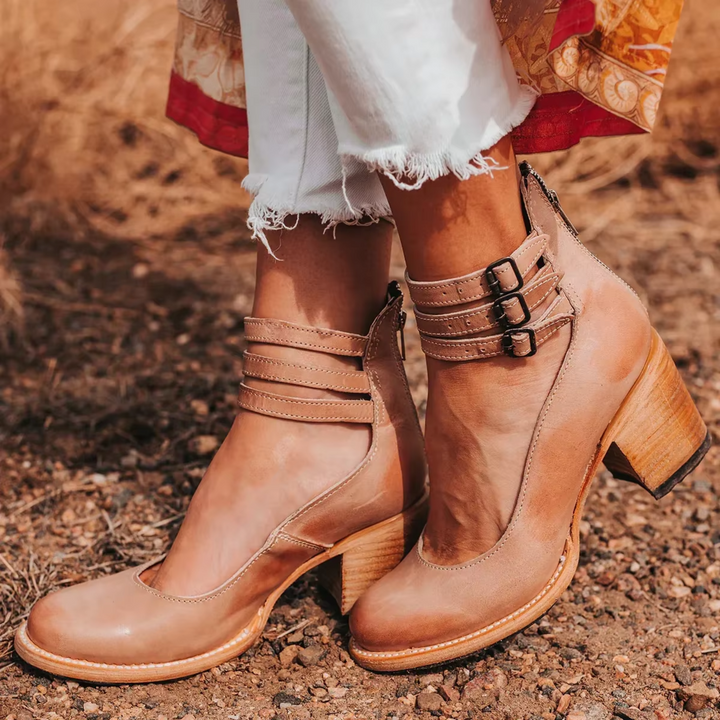 Model foot showcasing lightweight elegant sandal on soil ground.