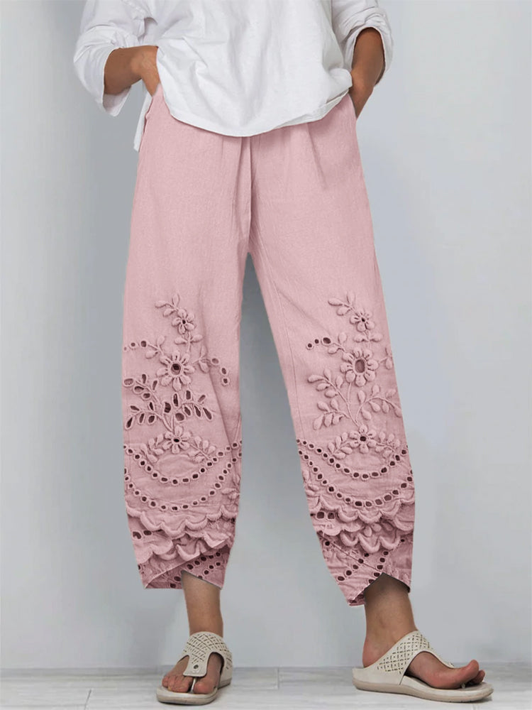Woman showcasing soft drape trousers on a plain background.