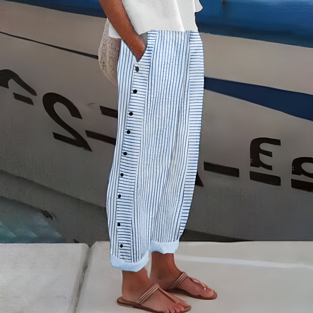 Female model wearing comfortable women’s pants with side pockets on a plain background.