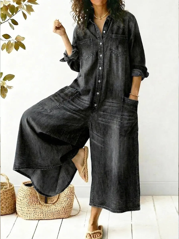 Female model in a black denim wide-leg jumpsuit styled for casual everyday wear.