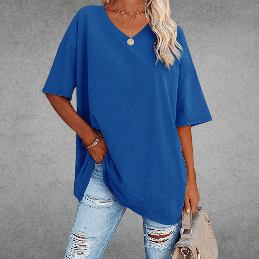 Front view of oversized V-neck top with bag, gray background.