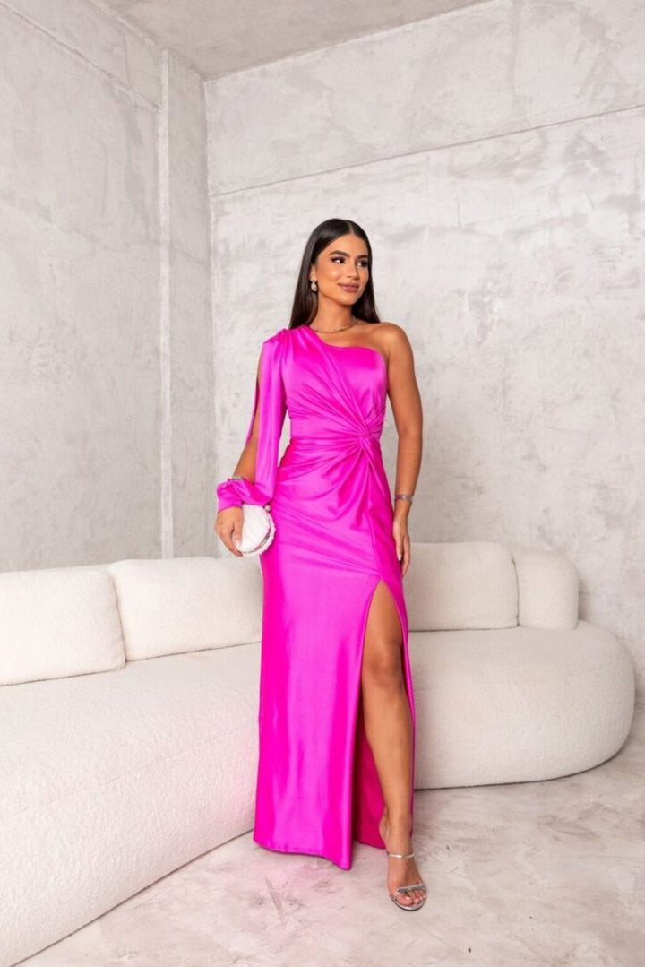 Model showcasing a graceful maxi dress with a plain background.