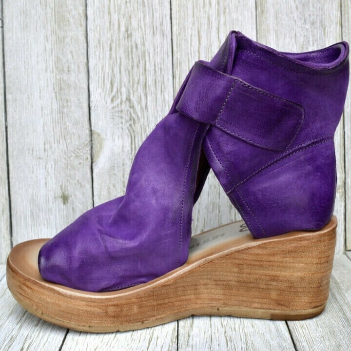 Everyday wedge sandals with secure strap detail displayed on a plain background.