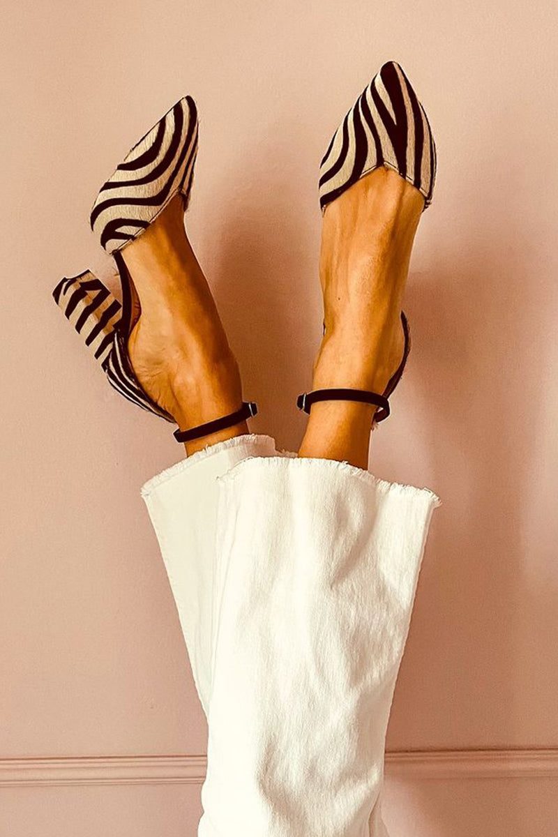 Zebra print mid heel sandal shown on a foot against a plain background.