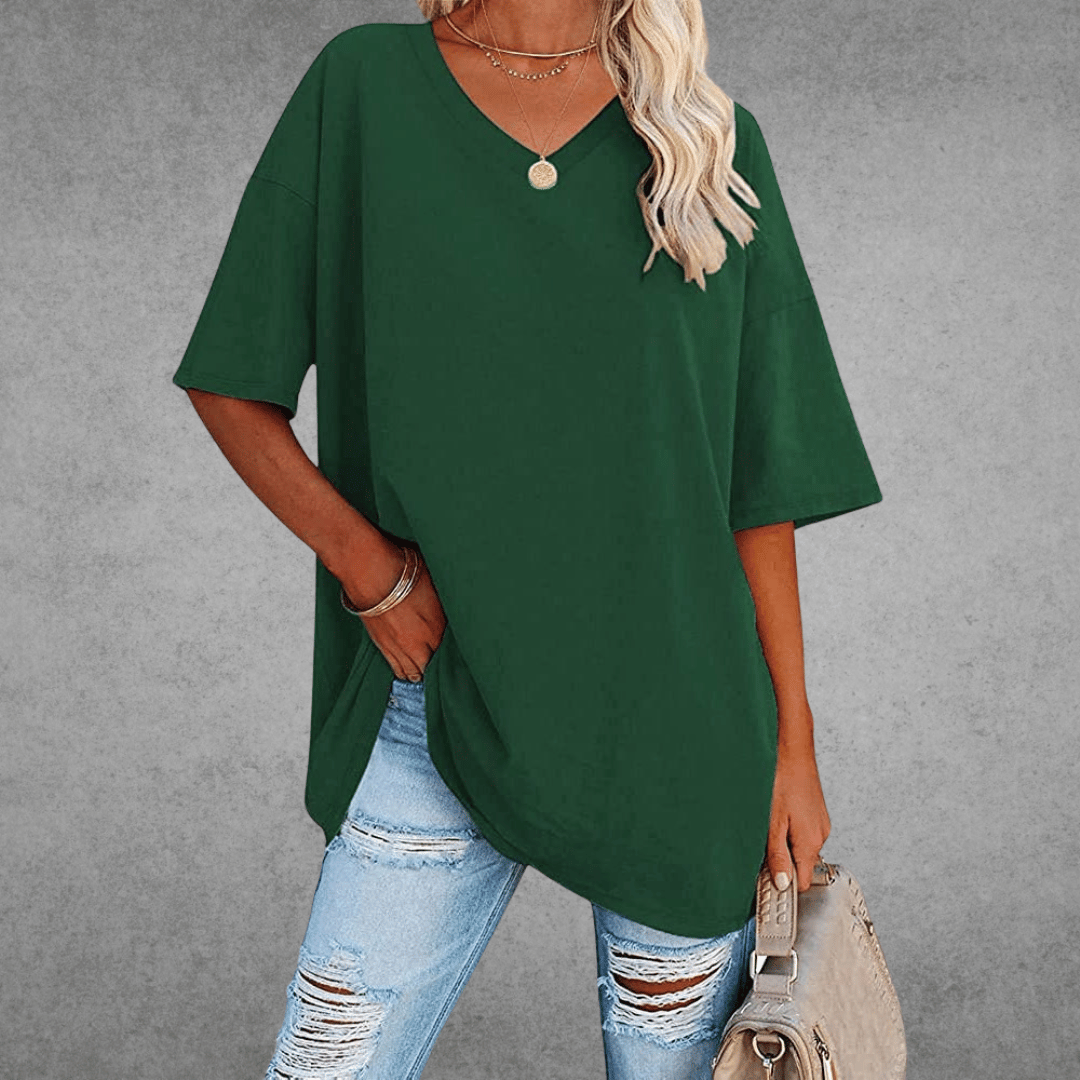 Relaxed everyday shirt on woman with bag, gray background view.