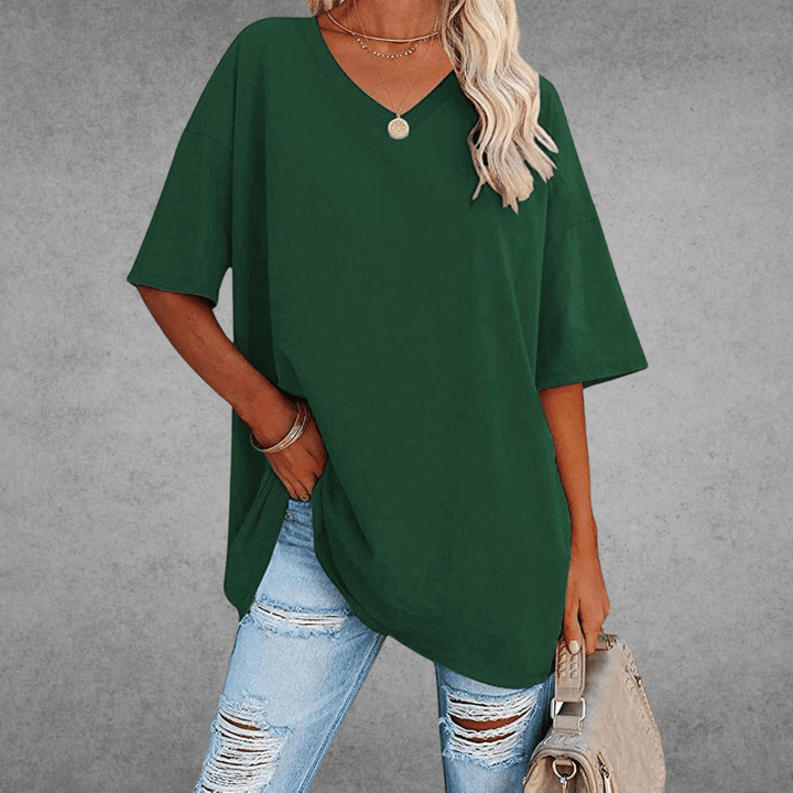 Relaxed everyday shirt on woman with bag, gray background view.