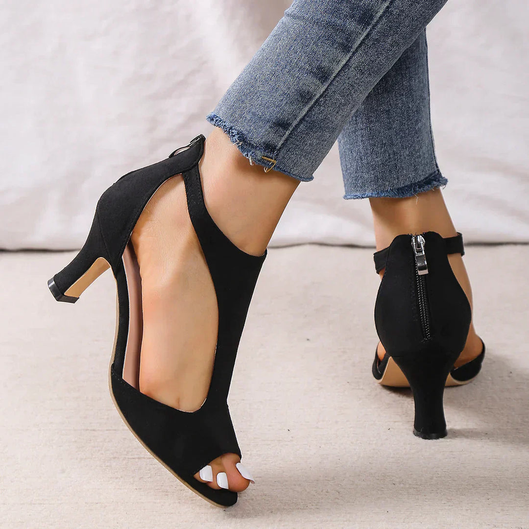 Elegant women’s comfort sandals with low heel shown on a plain background.