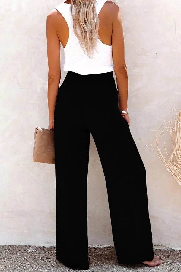 Female model wearing relaxed high-waisted trousers for everyday style, back view