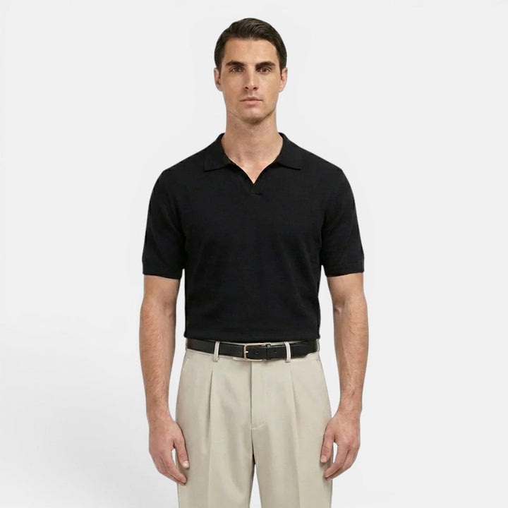Male model wearing pleated straight leg trousers on a plain background.