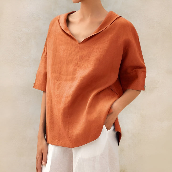 Stylish loose blouse displayed on a clean background with gentle draping and flattering shape.