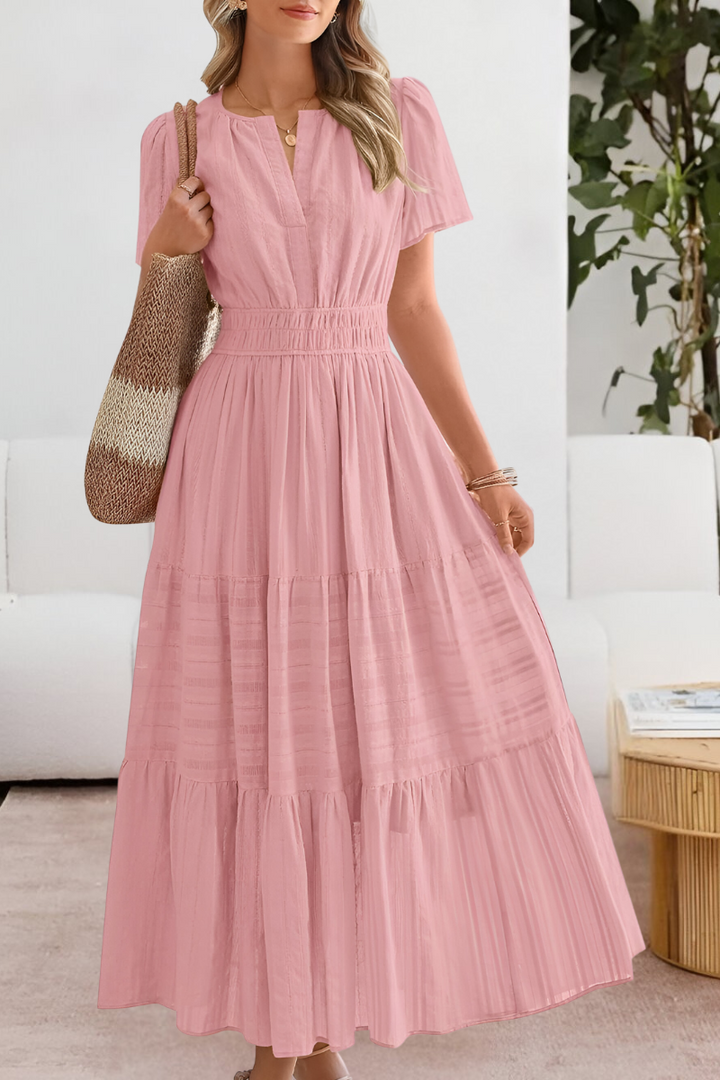 Lightweight maxi dress with flattering silhouette displayed on a plain background.