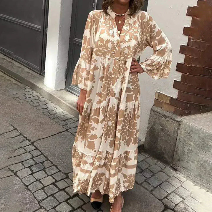 Woman wearing a boho printed mini dress against a plain background.