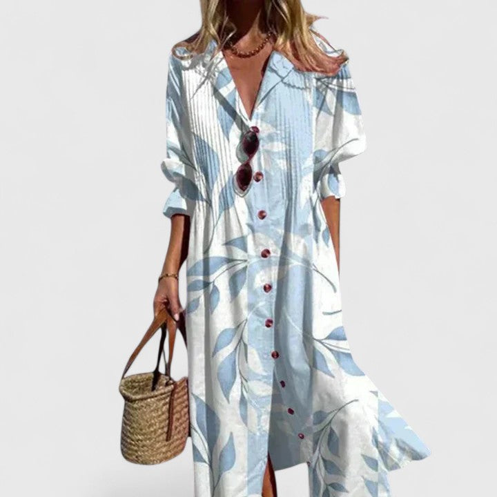 Female model wearing a floral button front midi dress on a plain background.