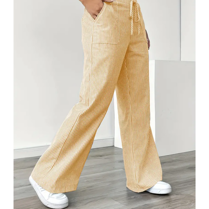 Women’s striped trousers with flowing drape shown against a plain background.