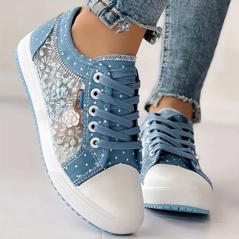 Female feet in supportive daily sneakers on a simple background.