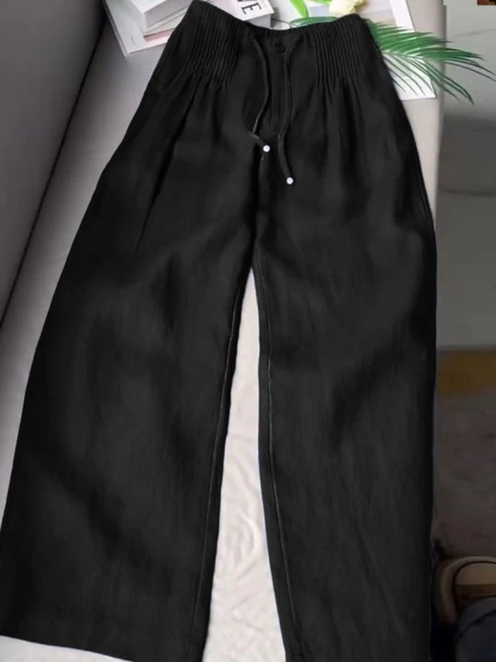 Wide-leg pants on plain background highlighting a relaxed leg shape.