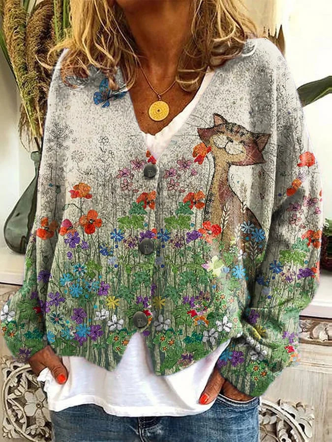 Individual styled in a cozy cat pattern cardigan against a clean background.