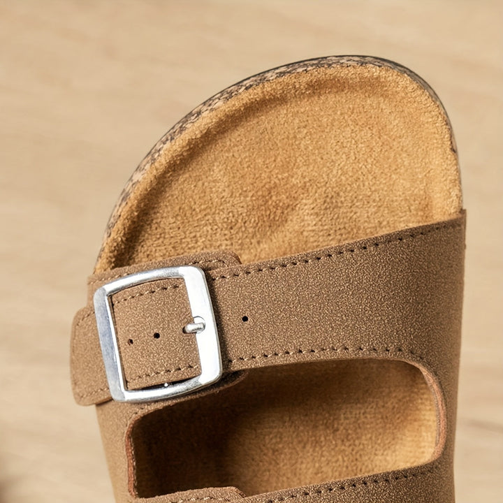 Slip-on sandals upper part against a neutral background.