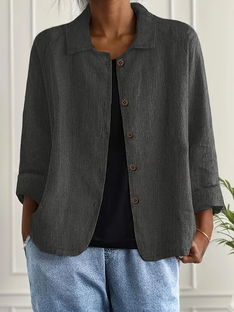 Timeless women’s top worn on a plain background with a smooth feminine outline.