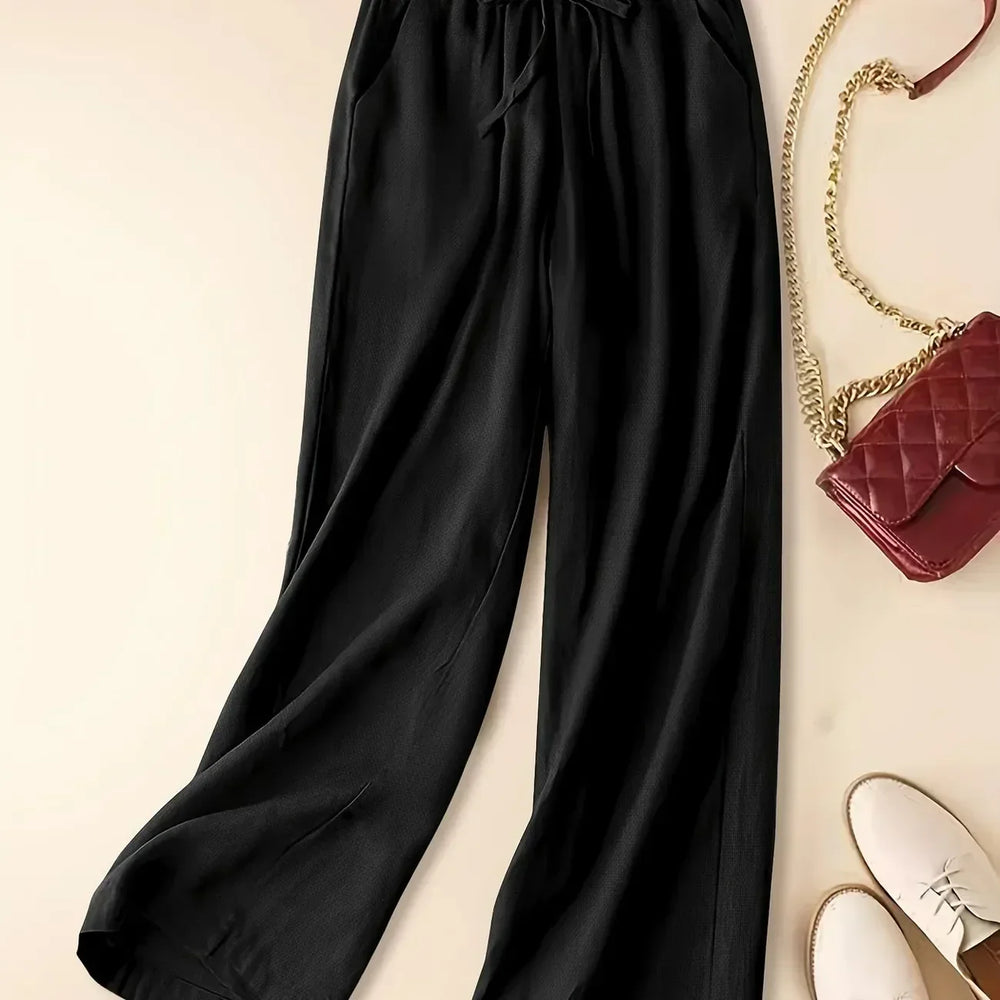 Female casual drawstring trousers shown on a beige background with a loose relaxed fit.