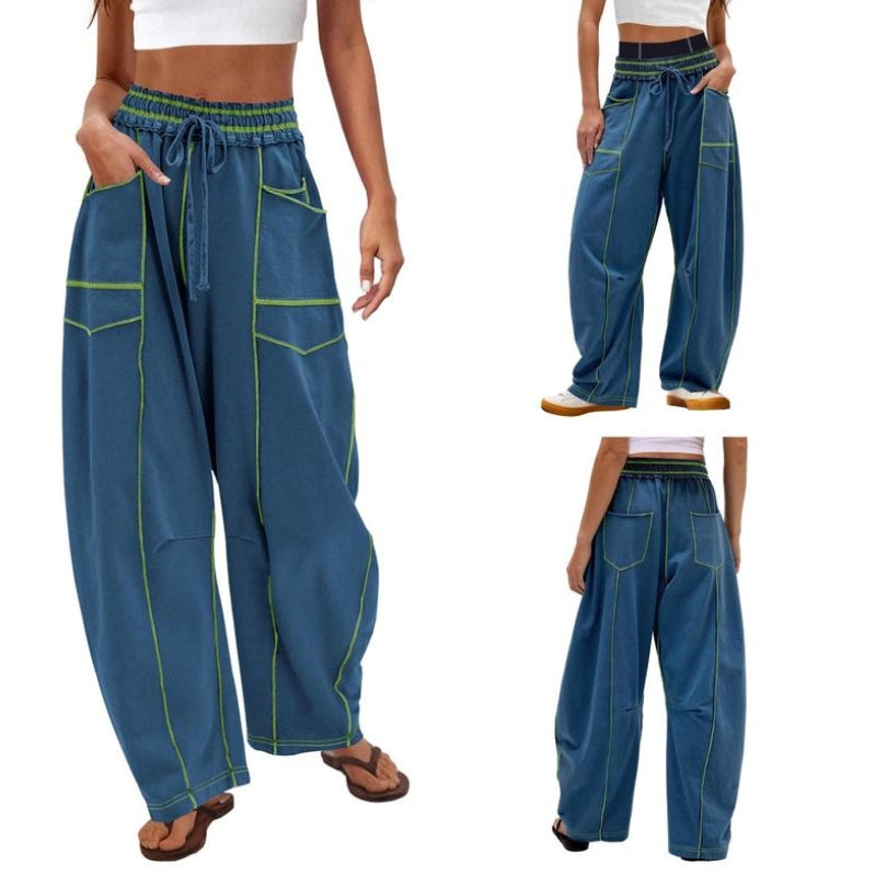 Woman posing in high-waist wide-leg cargo pants on a plain backdrop.