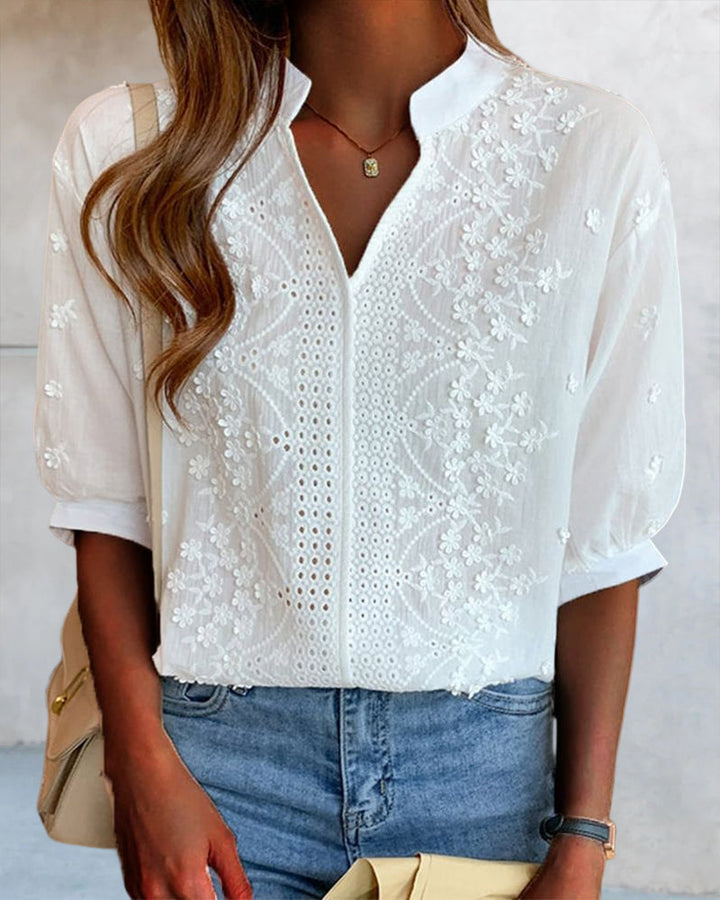 Angled front shot of lightweight blouse on plain background.