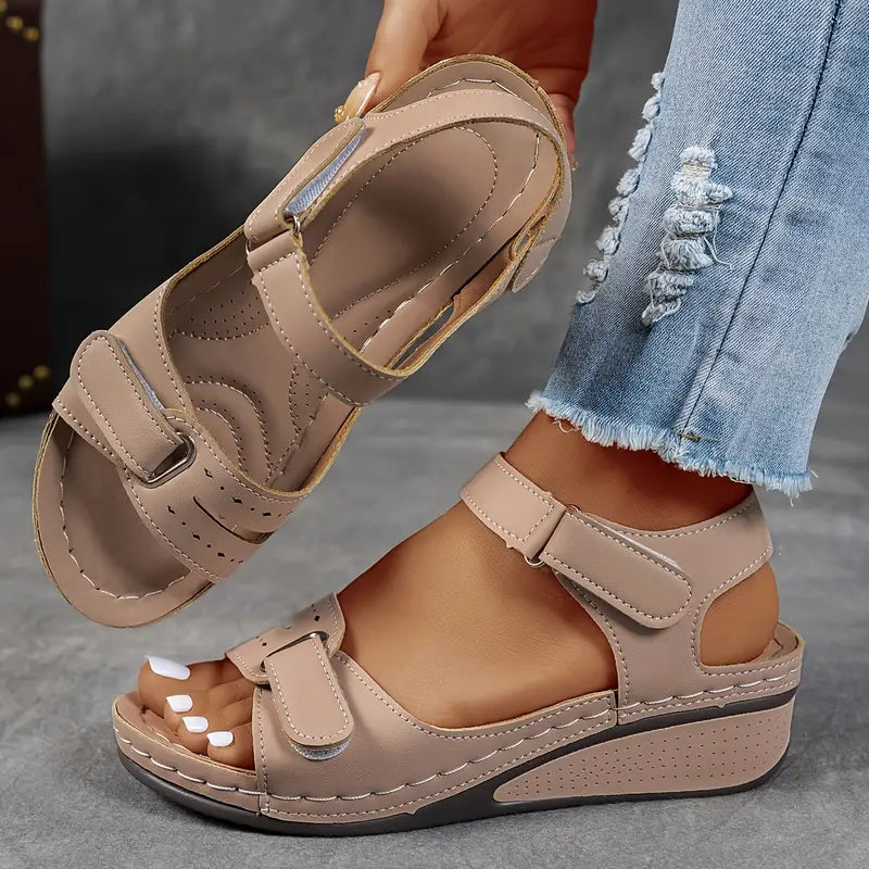 Foot in elegant comfort sandal with secure adjustable fit.