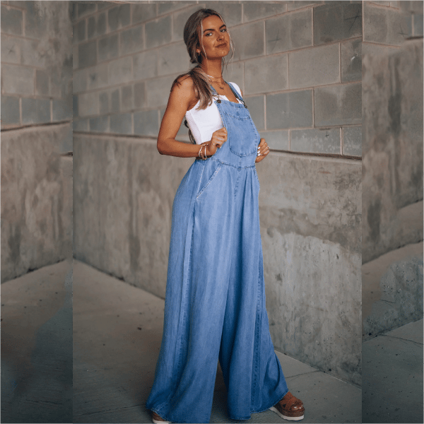 Casual women’s blue denim jumpsuit with adjustable shoulder straps.