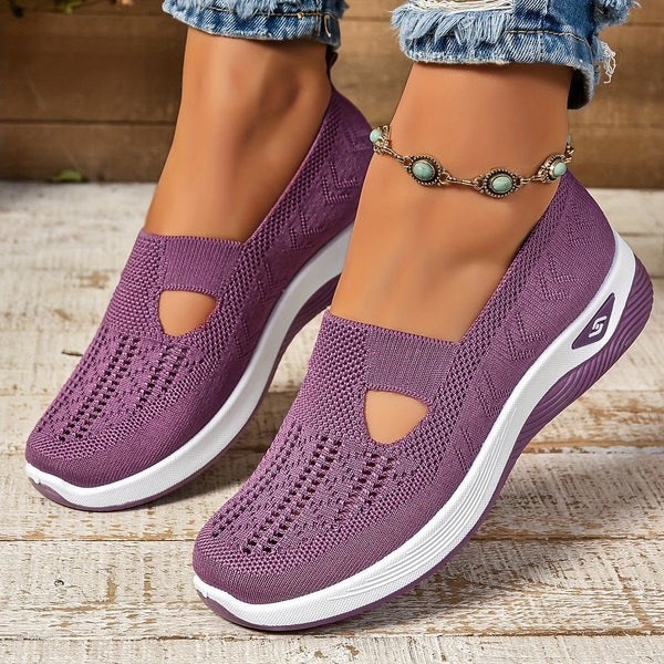 Woman standing in flexible everyday walking shoes on a clean background.