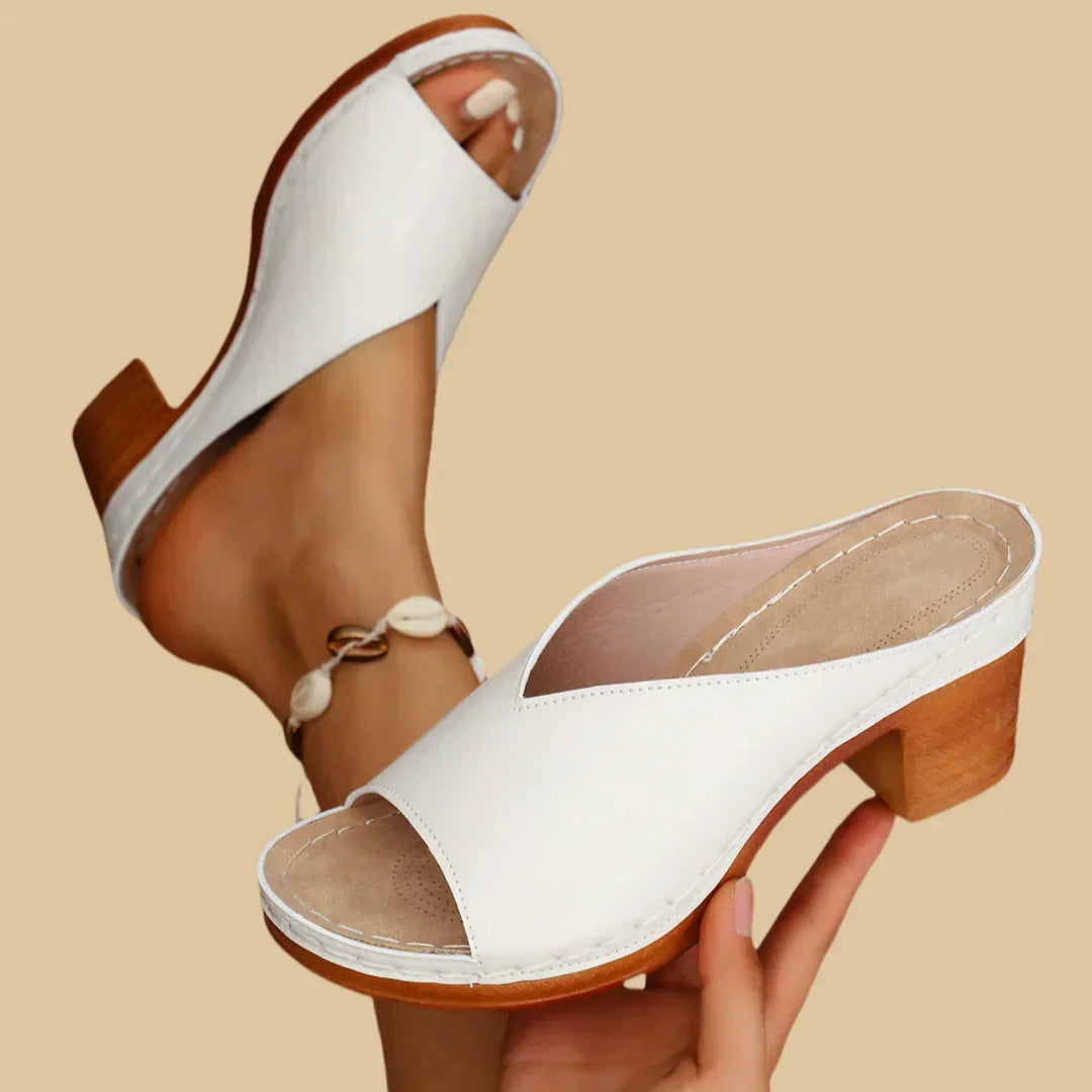 Open-toe sandal worn on foot with clean minimal background.