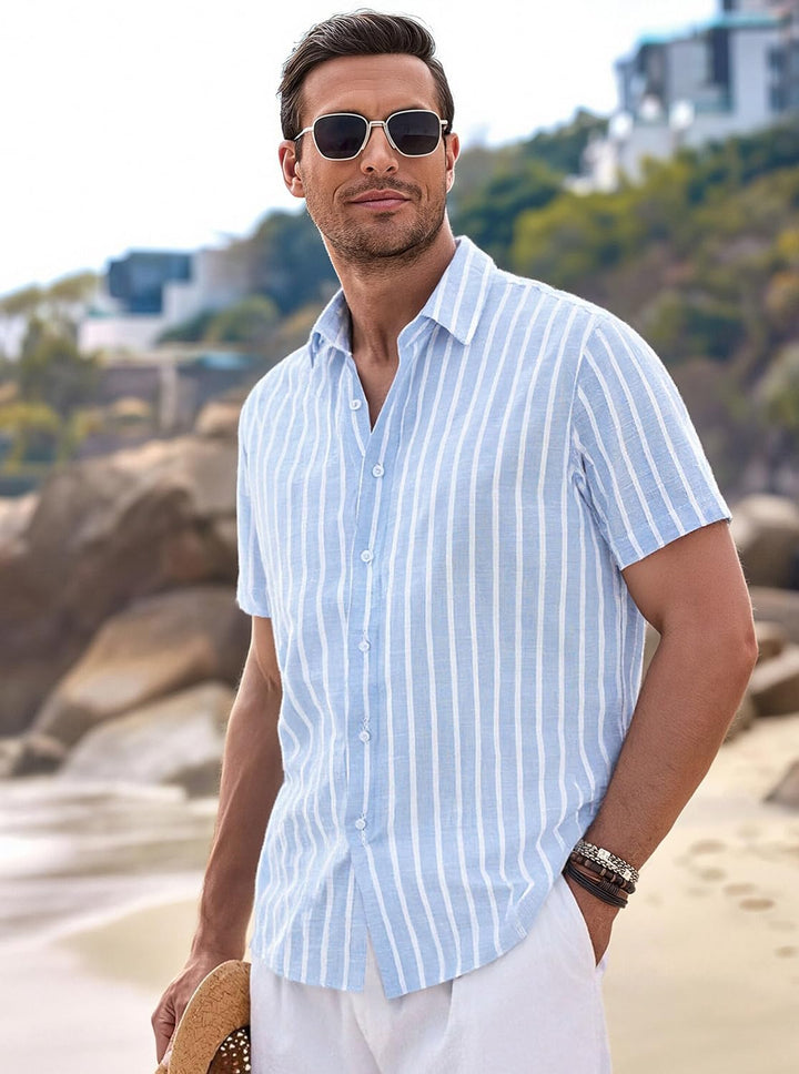  Male model in a relaxed striped short sleeve shirt on a plain background.