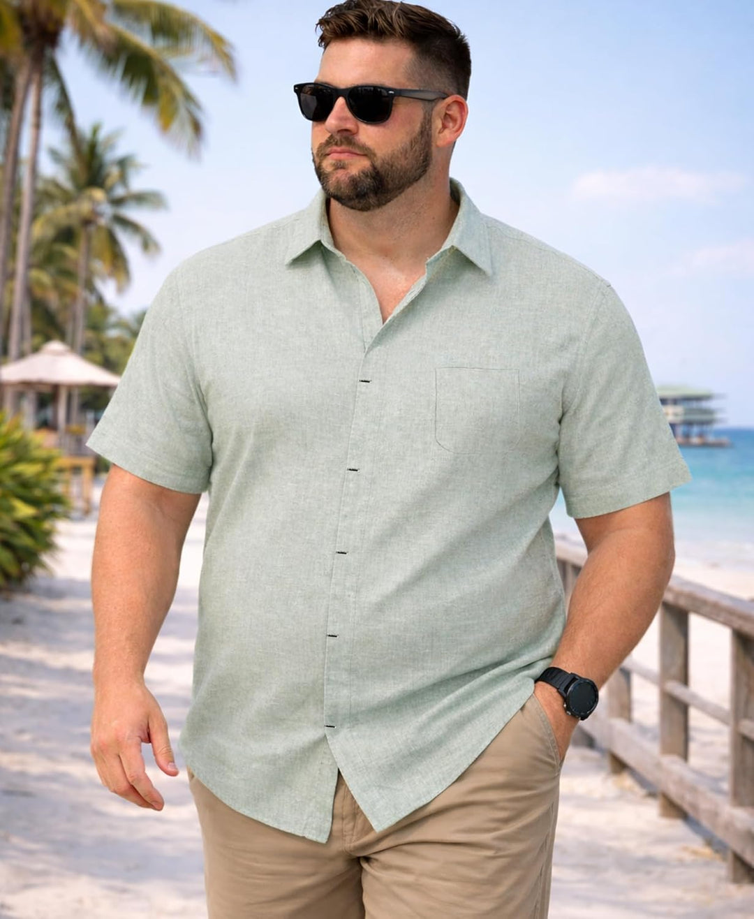 Male model wearing a short sleeve button-up shirt on a plain background.d.