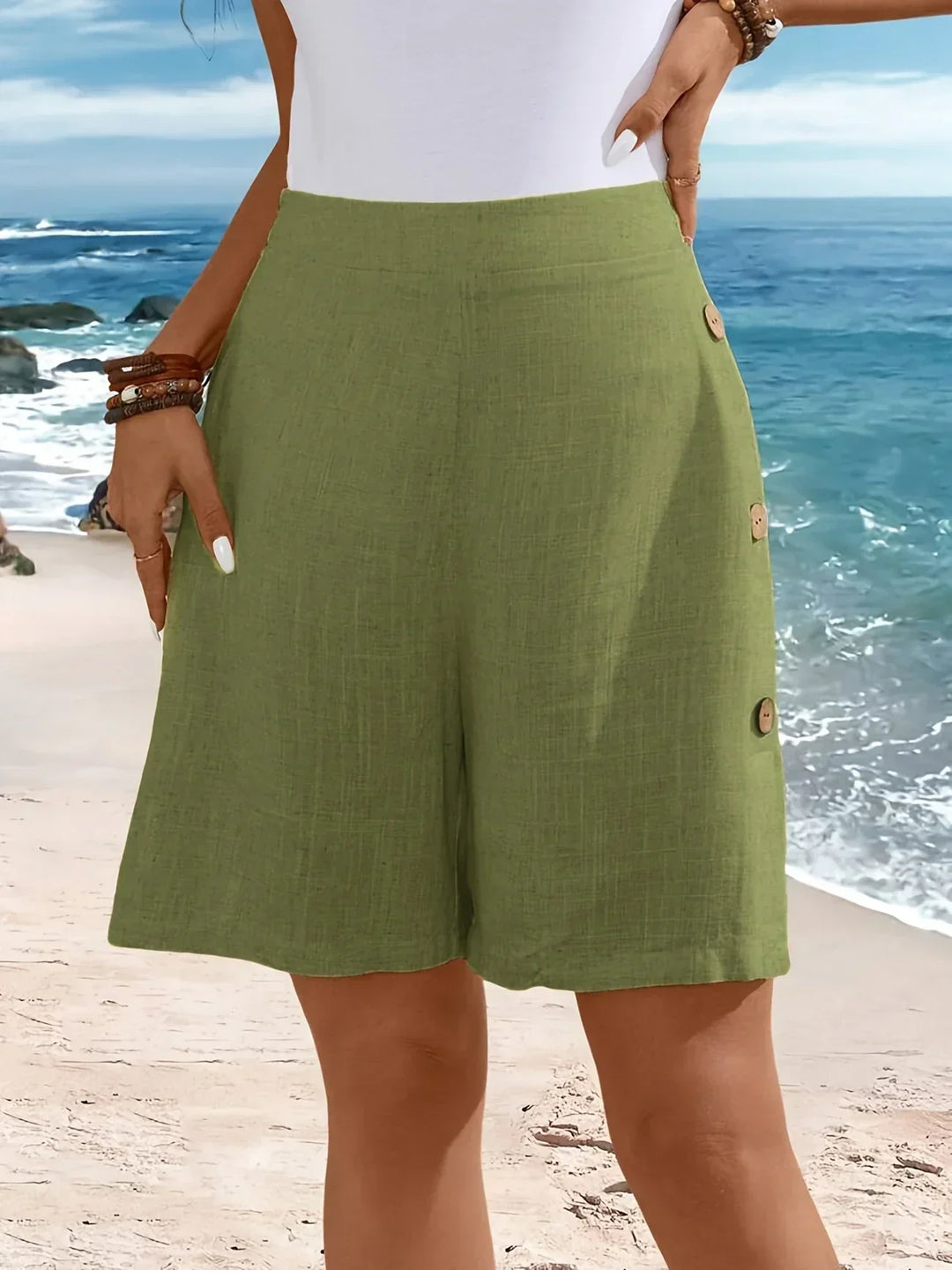 Female model showcasing high-waist shorts against a plain background.
