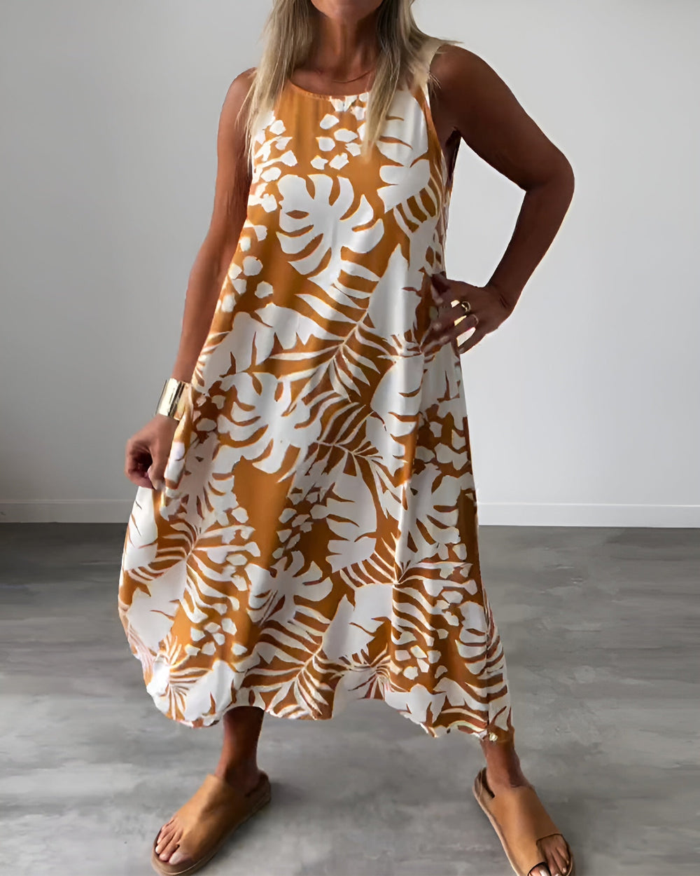 Sophisticated sleeveless dress featuring a graceful drape and feminine full-length style.