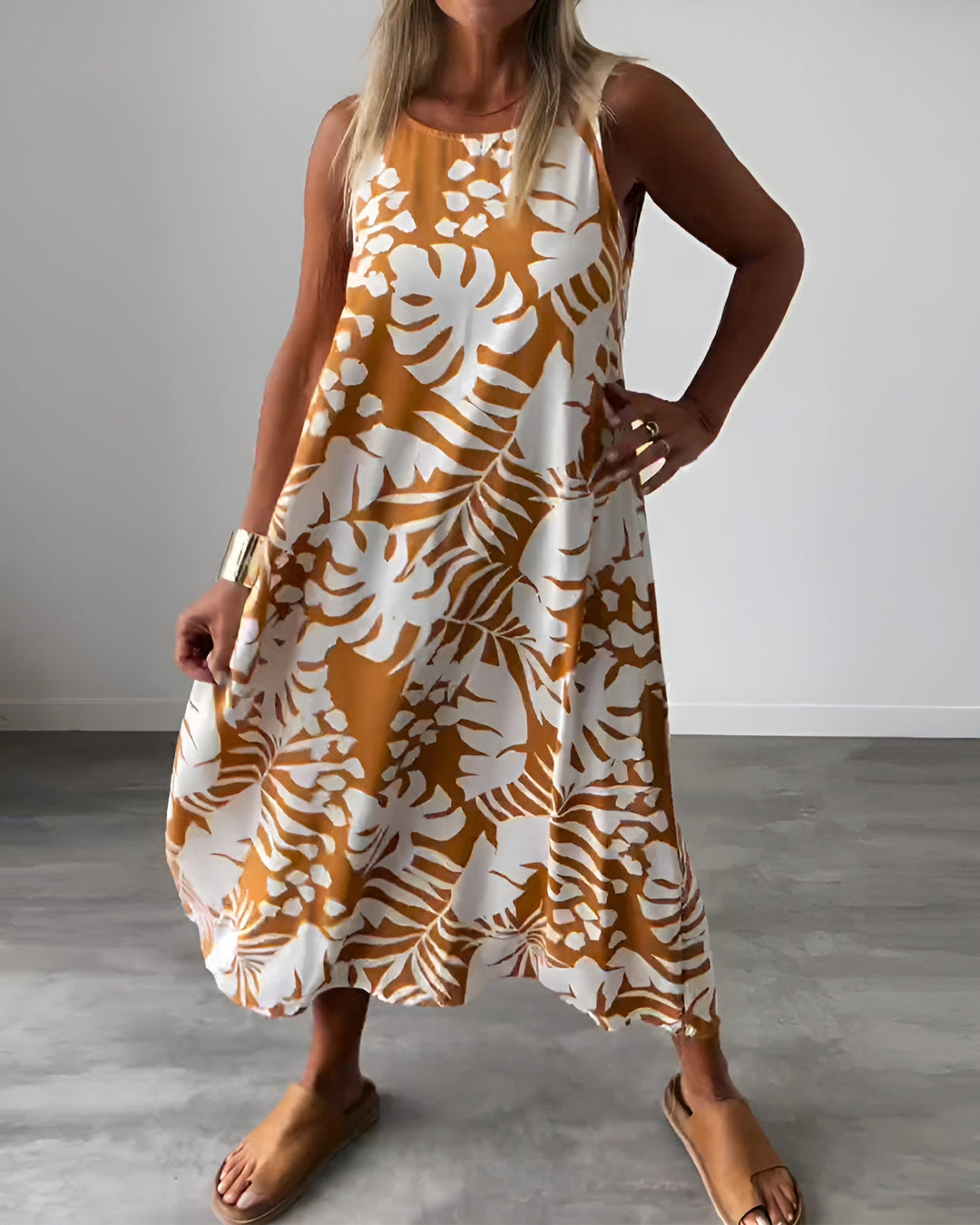 Sophisticated sleeveless dress featuring a graceful drape and feminine full-length style.