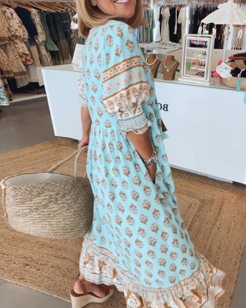 Midi dress displayed on a plain background with a loose silhouette and stylish tassel accents.