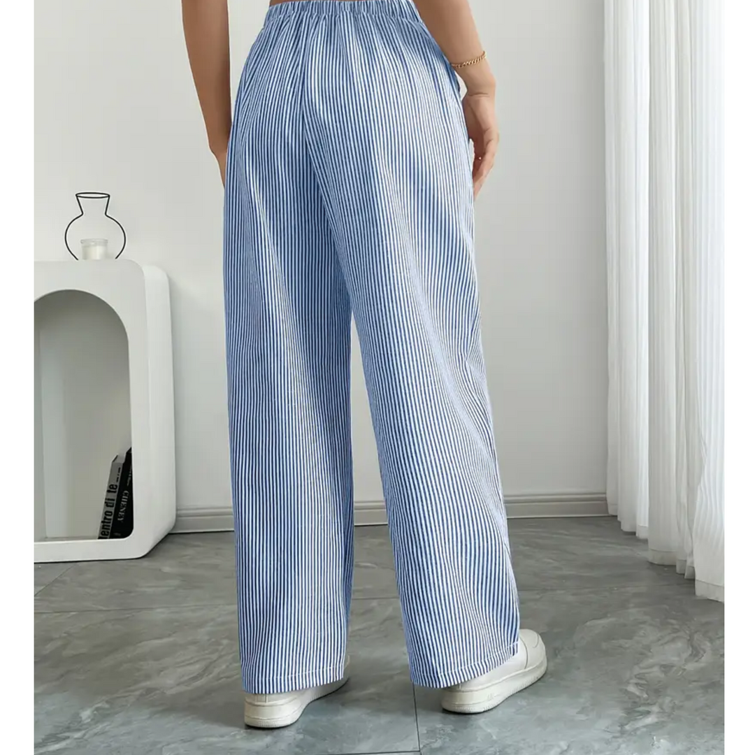 Relaxed women’s striped pants styled on a plain background.
