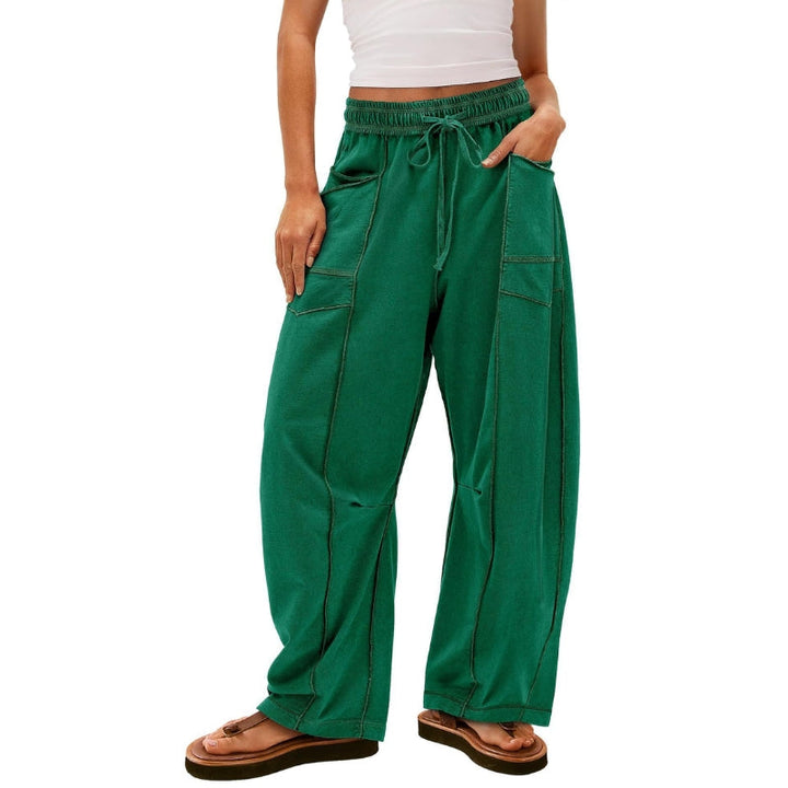 Female model wearing casual drawstring cargo pants with wide legs.
