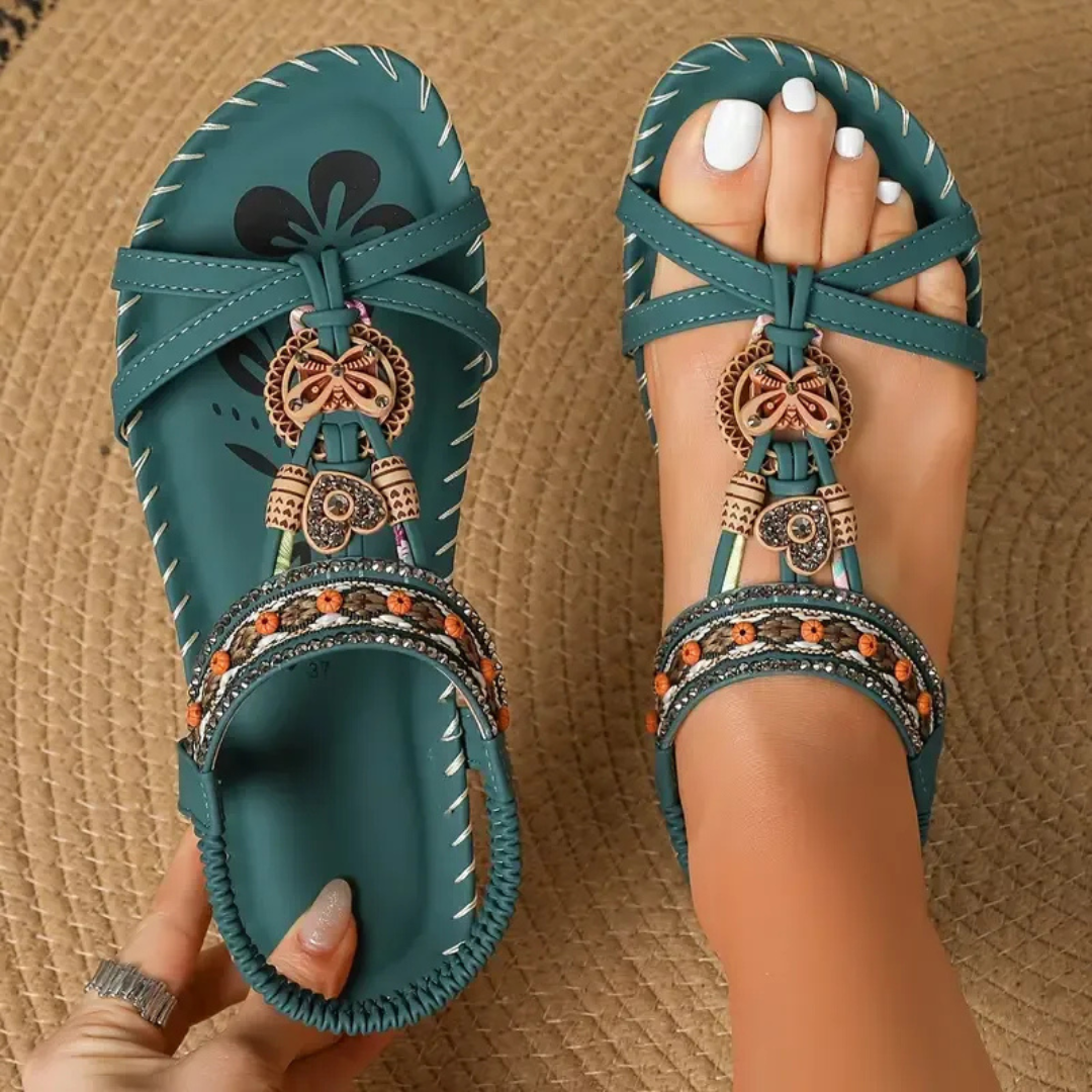 Foot wearing supportive sandals on a plain background.