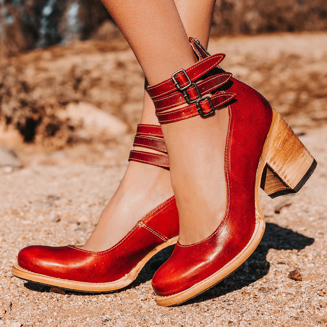 Model foot showcasing chic women’s sandal on a nature background.