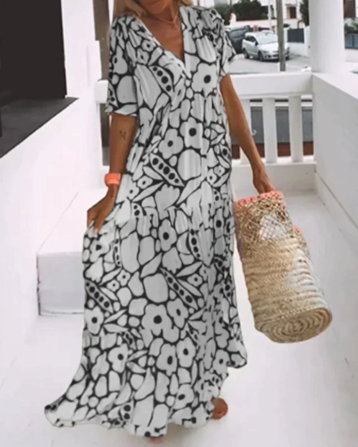 Elegant flowing dress paired with sandals for a casual daytime look.