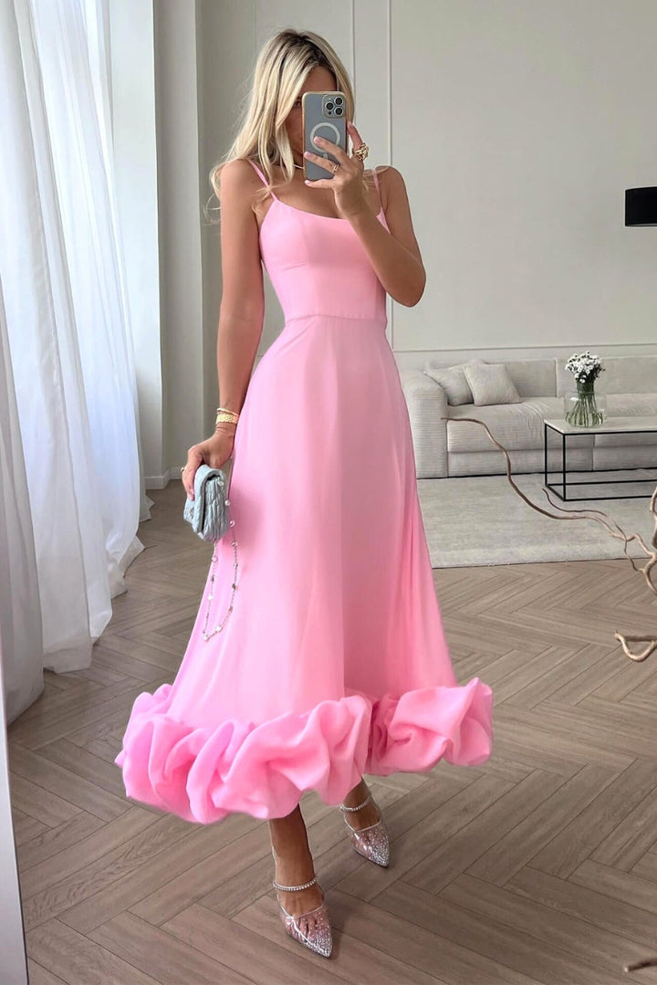 Female model wearing an elegant dress against a clean background.