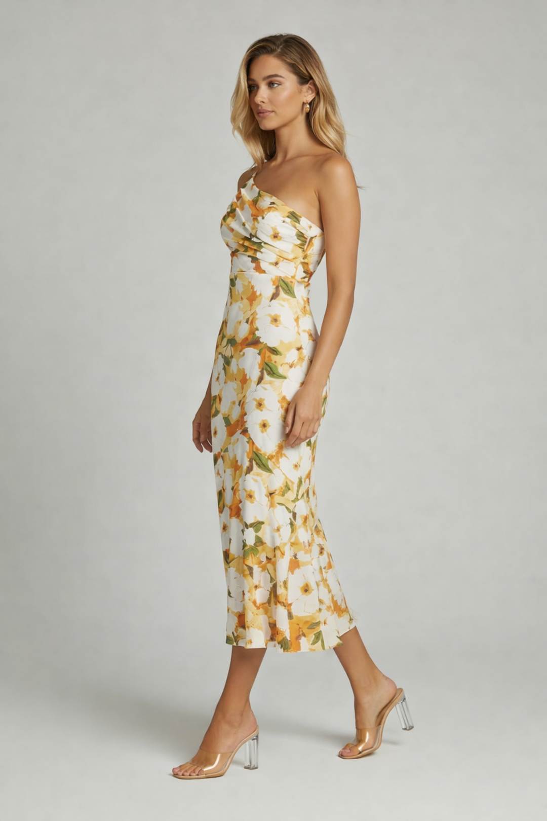 Woman wearing an floral midi dress on a plain background.