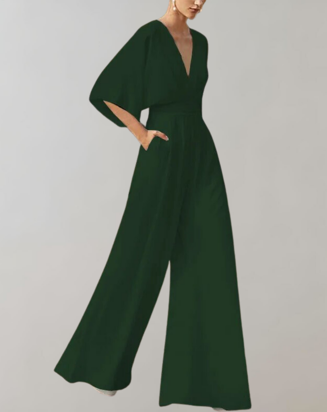 Female model in a deep V-neck one-piece outfit with wide-leg design.