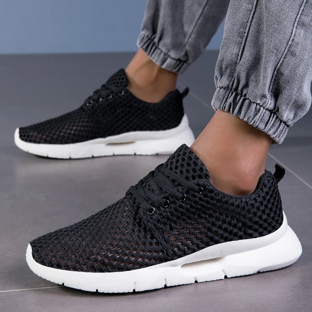Side view of women’s low-top sneakers on a plain background.