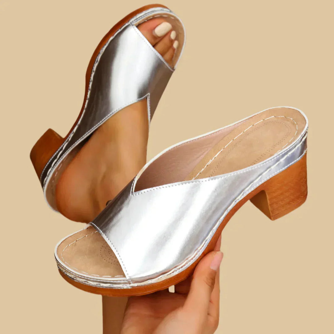 Close-up of foot in cushioned open-toe sandal on clean background.