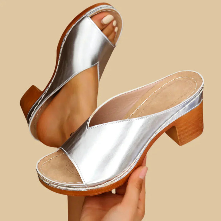 Close-up of foot in cushioned open-toe sandal on clean background.