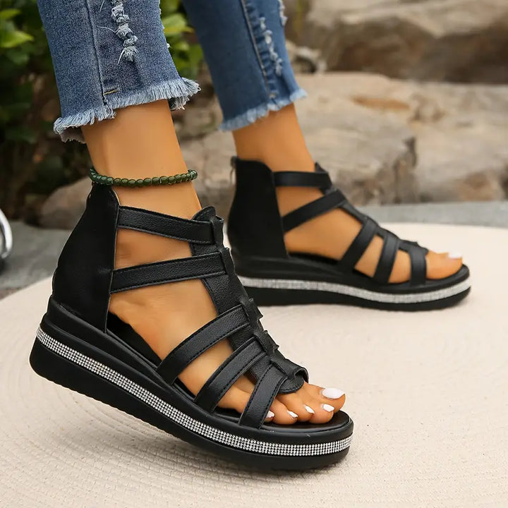 Model feet showing elegant supportive sandals with delicate rhinestone detailing.
