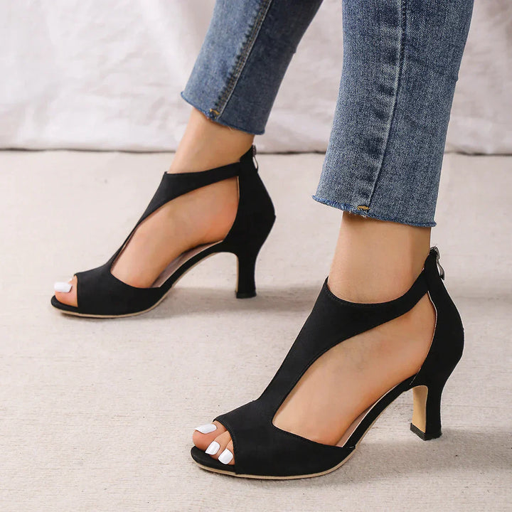 Stylish women’s low heel sandals displayed on a clean plain background.